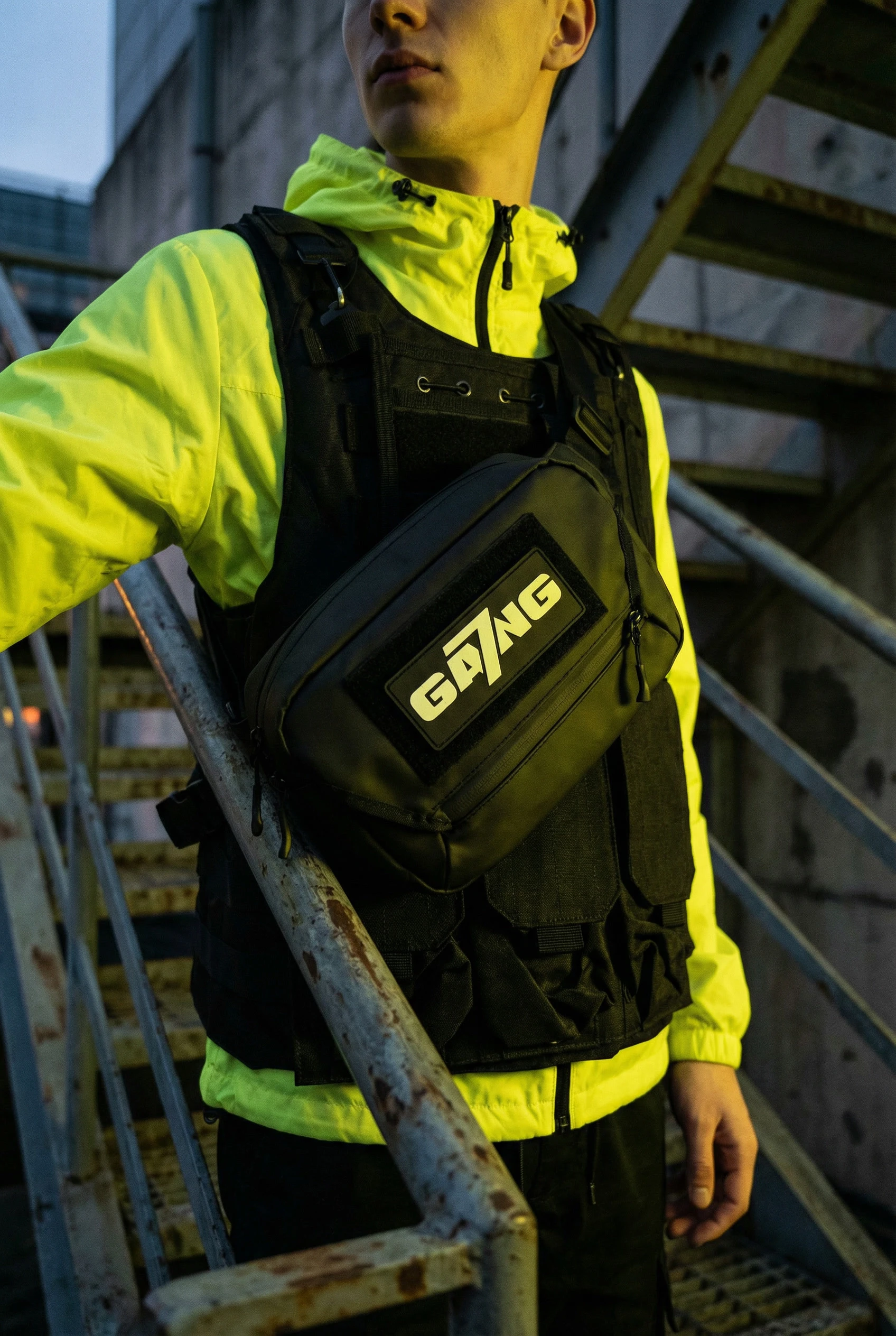 gemini-image-2_product-on-body_model_wearing_black_sling_bag_across_chest_velcro_patch_“GA7NG-2.jpg