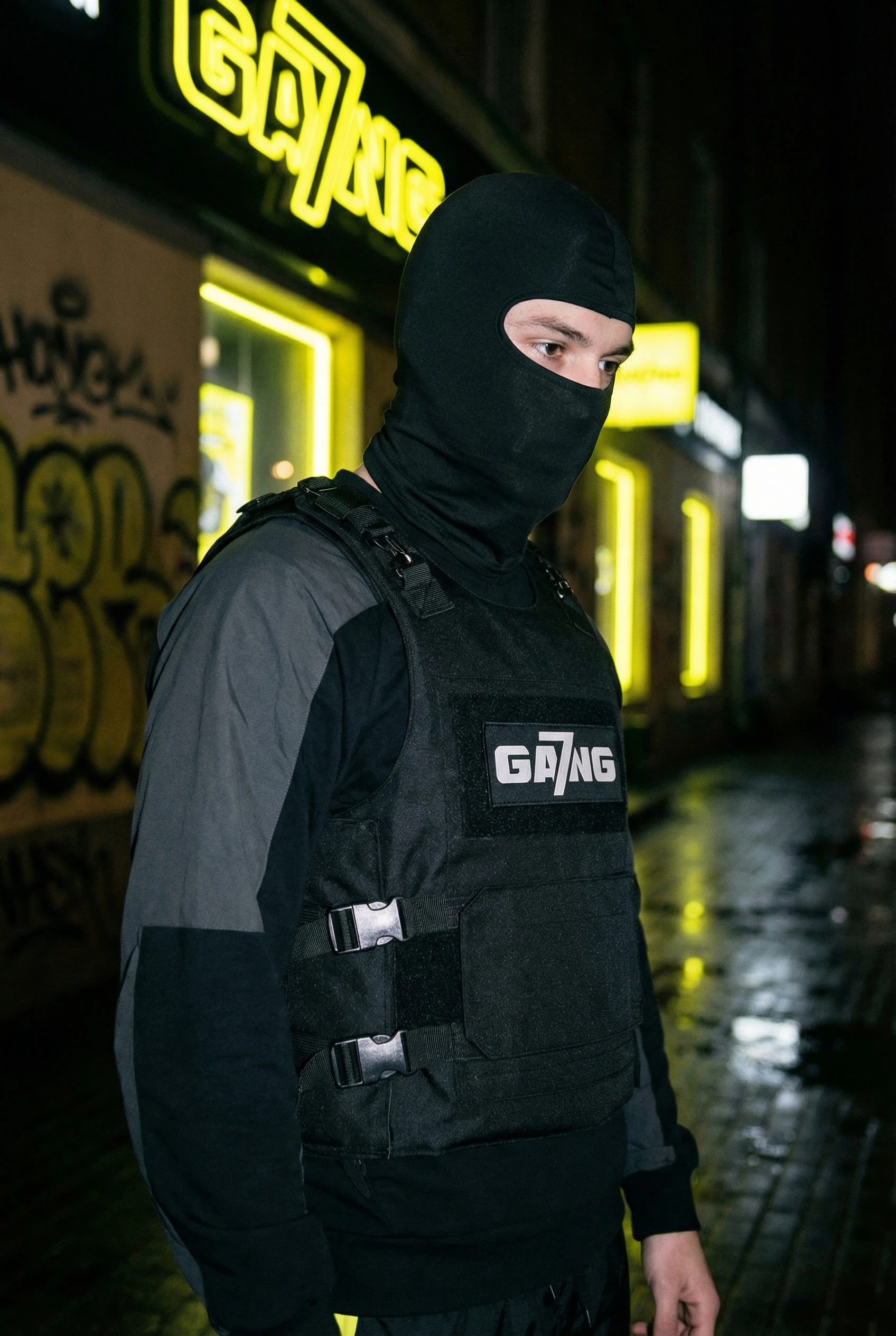 gemini-image-2_night_street_direct_on-camera_flash_model_in_black_utility_vest_plus_balaclava_r-3.jpg